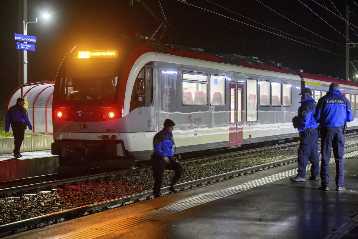 Vaud cantonal police officers watch the Travys train where a hostage-taking incident took place at Essert-sous-Champvent station, Switzerland, Thursday, Feb. 8, 2024. A hostage-taking incident took pl ...