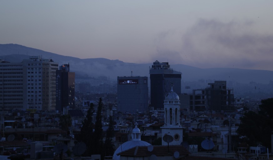 Smoke rises after airstrikes targeting different parts of the Syrian capital Damascus, Syria, early Saturday, April 14, 2018. Syria&#039;s capital has been rocked by loud explosions that lit up the sk ...