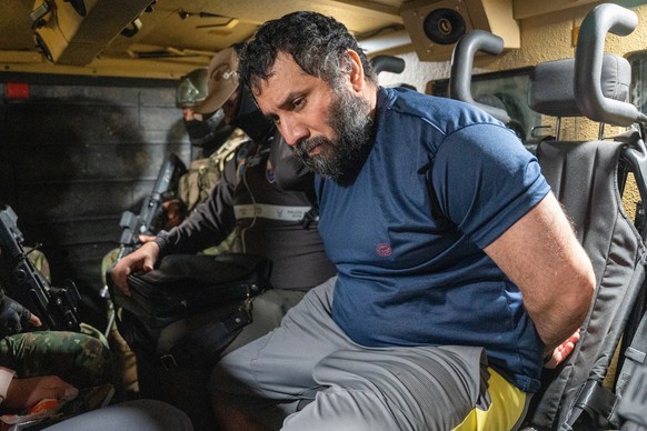 epa12198026 Drug trafficker Jose Adolfo Macias Villamar &#039;Fito&#039; (R) is guarded as he is moved in Guayaquil, Ecuador, 25 June 2025. &#039;Fito&#039; arrived at the Guayaquil Air Base after bei ...