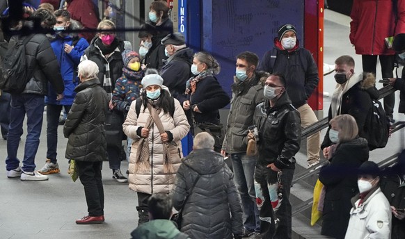 People wear mandatory face masks at a subway station in the city center of Essen, Germany, on Wednesday, Jan. 12, 2021. Germany registered a new record of more than 80,000 new infections with the coro ...