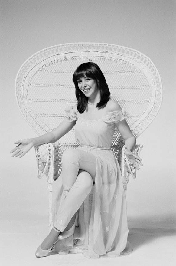 Gali Atari, Israeli singer, posing for a studio portrait, sitting in a white rattan chair, against a light background, United Kingdom, in April 1979. Atari performed with the group Milk and Honey, rep ...