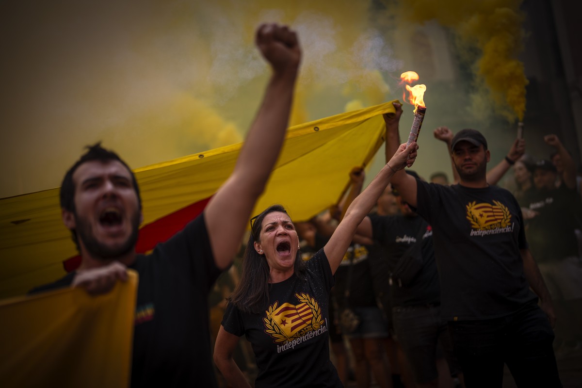 Protesters hold independence flags and flares as they shout slogans calling for Catalonia's independence from Spain, during the Catalan National Day, in Barcelona, Spain, Monday, Sept. 11, 2023.  ...