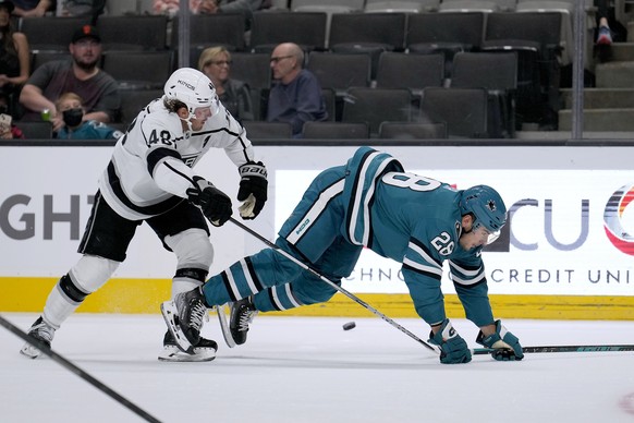 San Jose Sharks forward Timo Meier (28) is tripped by Los Angeles Kings&#039; Brendan Lemieux (48) in the first period of a preseason NHL hockey game in San Jose, Calif., Sunday Sept. 25, 2022. (AP Ph ...
