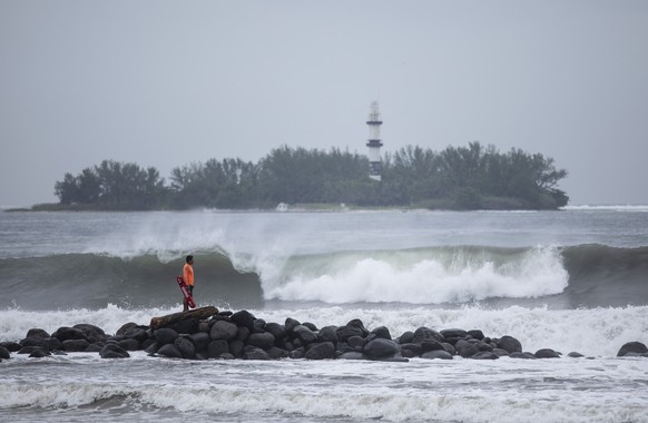 A lifeguard watches the surf in Boca del Rio, in the Veracruz state of Mexico, Friday, Aug. 20, 2021. Residents began making preparations for the arrival of Tropical Storm Grace. (AP Photo/Felix Marqu ...