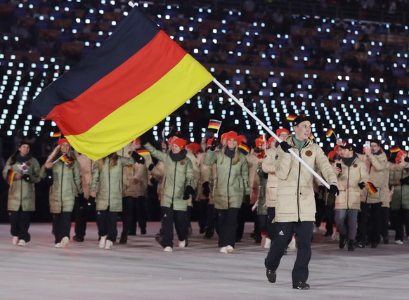 Eric Frenzel carries the flag of Germany during the opening ceremony of the 2018 Winter Olympics in Pyeongchang, South Korea, Friday, Feb. 9, 2018. (AP Photo/Petr David Josek)