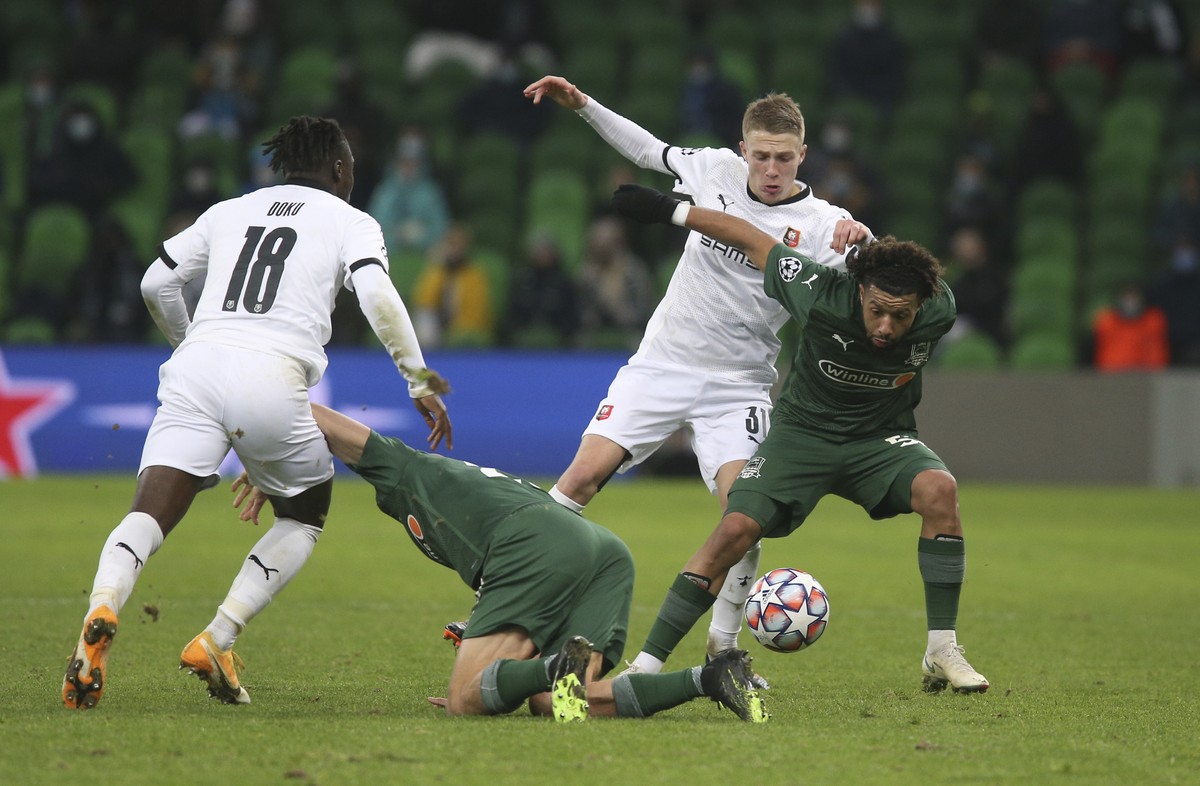 Krasnodar's Tonny Vilhena, right, and Rennes' Adrien Truffert challenge for the ball during the UEFA Champions League, Group E, soccer match between Krasnodar and Rennes at the Krasnodar Sta ...