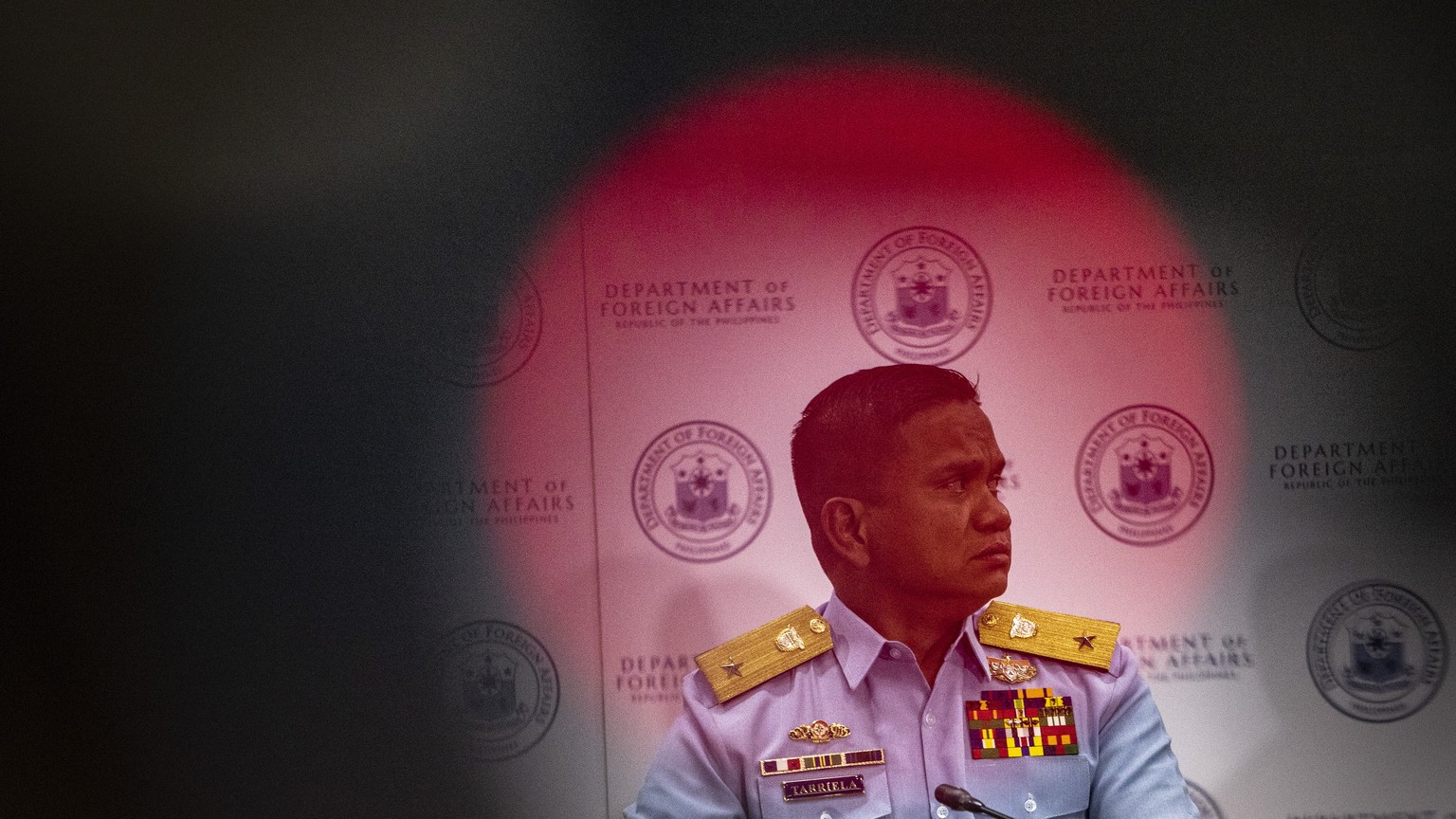 epa10788846 Philippine Coast Guard (PCG) Commodore Jay Tarriela, spokesperson for the West Philippine Sea, listens during a press conference at the Department of Foreign Affairs office in Manila, Phil ...