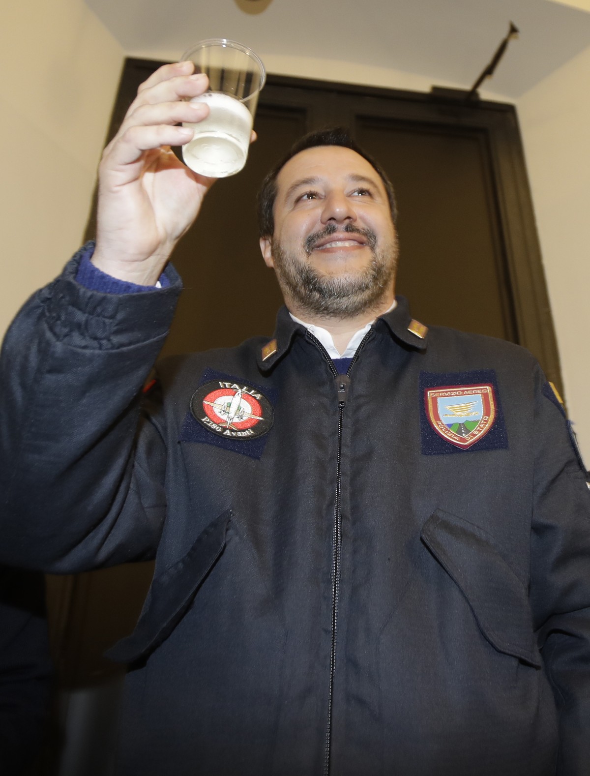 Italy's Interior Minister Matteo Salvini greet the journalists with a toast, in Milan, Italy, Wednesday, Dec. 19, 2018. (AP Photo/Luca Bruno)