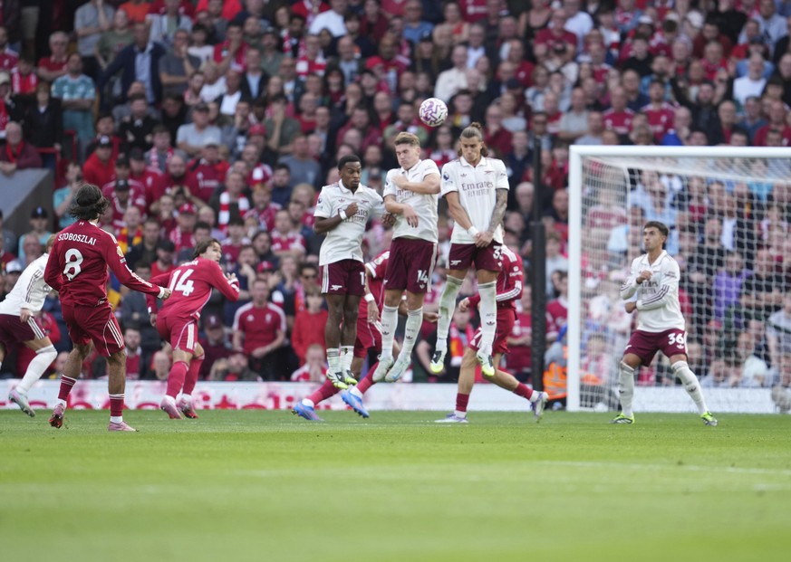 Liverpool&#039;s Dominik Szoboszlai, left, shoots to score his sides first goal during the English Premier League soccer match between FC Liverpool and FC Arsenal in Liverpool, England, Sunday, Aug. 3 ...