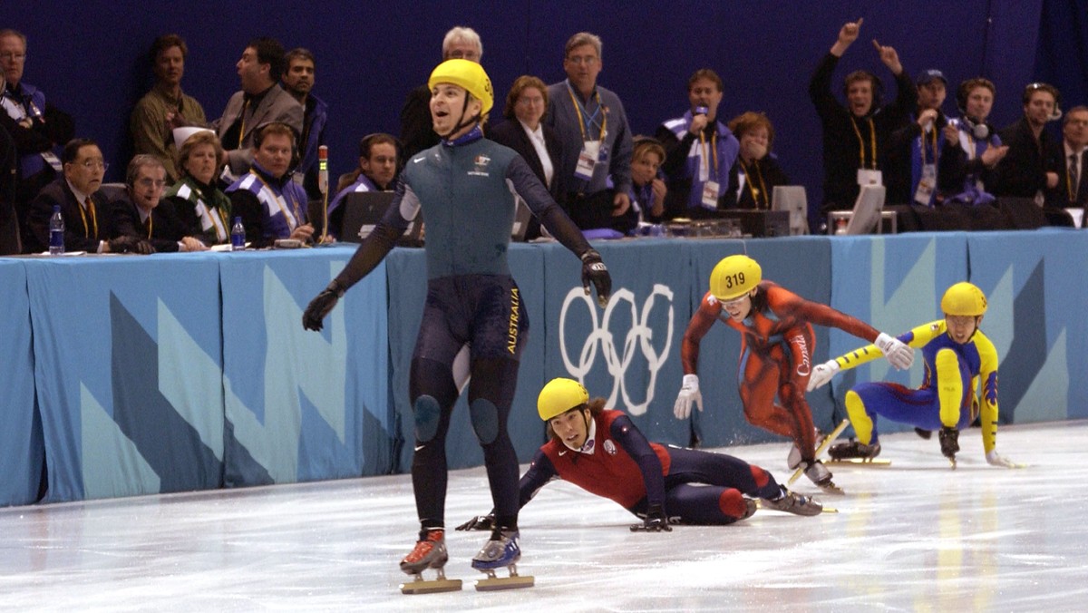 16 Feb 2002: Australia's first ever Winter Gold medal winner Steven Bradbury crosses the line while America's Apolo Anton Ohno scrambles for the line to claim second place after the men' ...