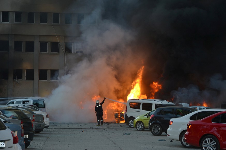 A firefighter tries to extinguish burning vehicles after an explosion outside the governor&#039;s office in the southern city of Adana, Turkey, November 24, 2016. Ihlas News Agency via REUTERS ATTENTI ...