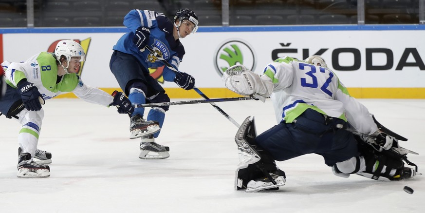 Slovenia&#039;s Ziga Jeglic, left, challenges Finland&#039;s Antti Pihlstrom, center, as he shoots wide past Slovenia&#039;s Gasper Kroselj, right, during the Ice Hockey World Championships group B ma ...