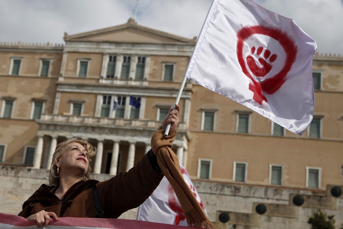 A woman waves a flag depicting a symbol of feminism during a march to celebrate International Women's Day in Athens March 8, 2014. On March 8 activists around the globe celebrate International Wo ...