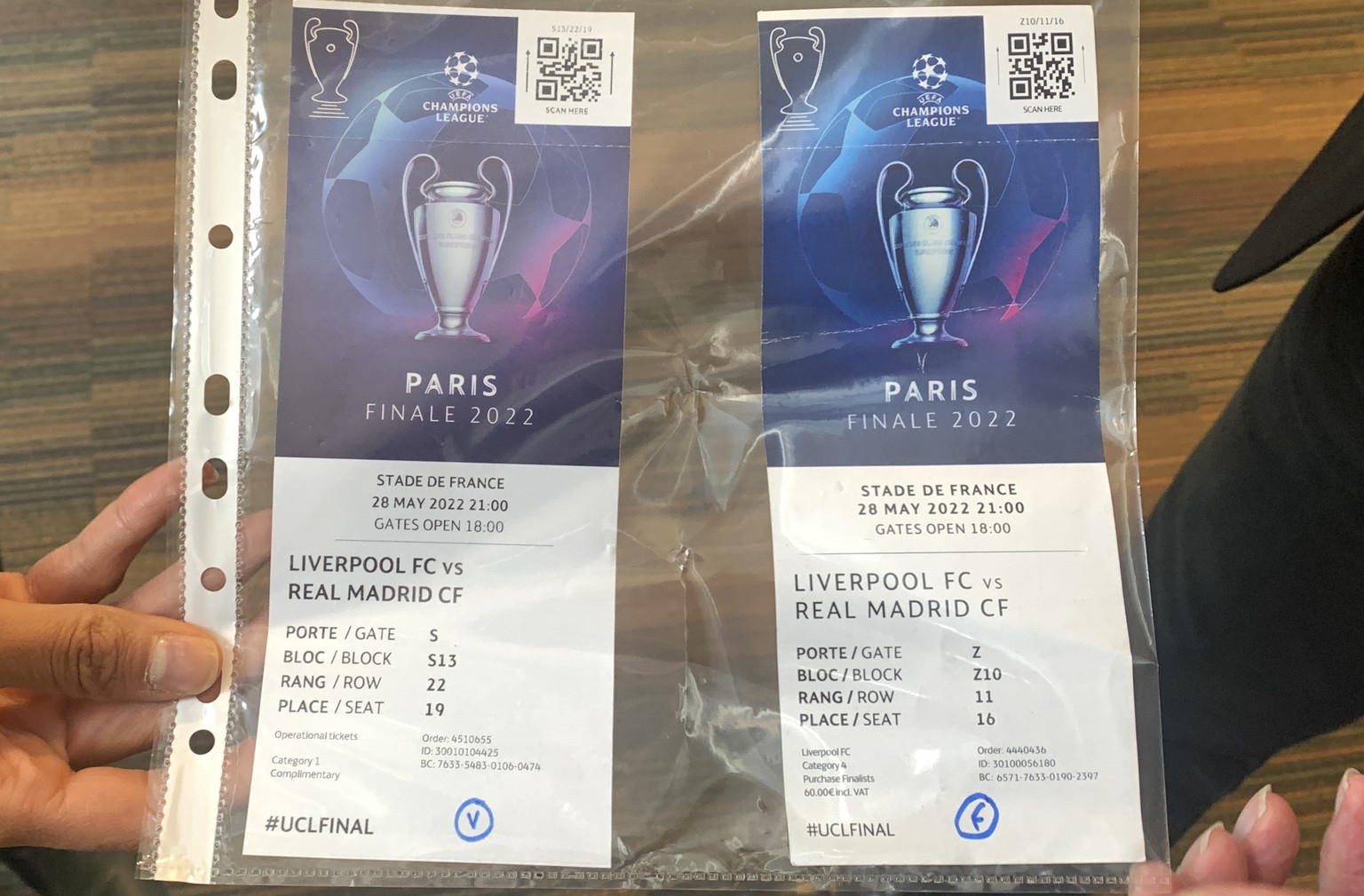 A real, left, and a fake ticket for the Champions League final are displayed at a press conference in Paris Monday, May 30, 2022 following a meeting on security after incidents during the Champions Le ...