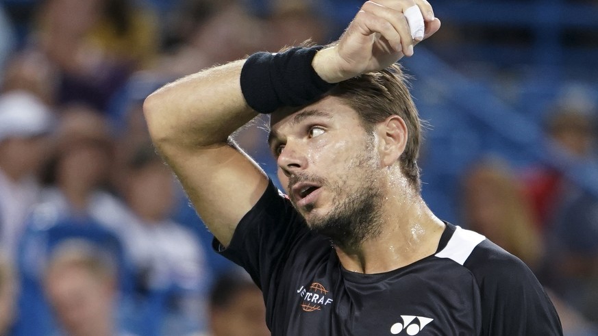Stan Wawrinka, of Switzerland, reacts during a match against Roger Federer, of Switzerland, in the quarterfinals of the Western &amp; Southern Open tennis tournament, Friday, Aug. 17, 2018, in Mason,  ...