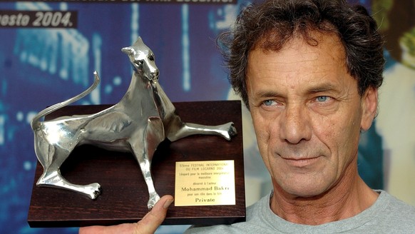 EMBARGOED UNTIL SATURDAY, AUGUST 14, 9:00 PM === Palestinian actor Mohammad Bakri poses with the Lepoard for the best actor, he received for his role in Italian director and Golden Leopard winner Save ...