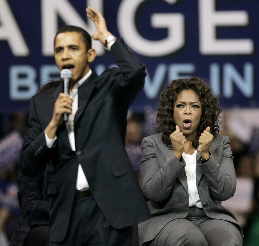 Democratic presidential hopeful, Sen. Barack Obama, D-Ill., speaks as Oprah Winfrey reacts at a rally in Manchester, N.H. Sunday, Dec. 9, 2007. (AP Photo/Elise Amendola)