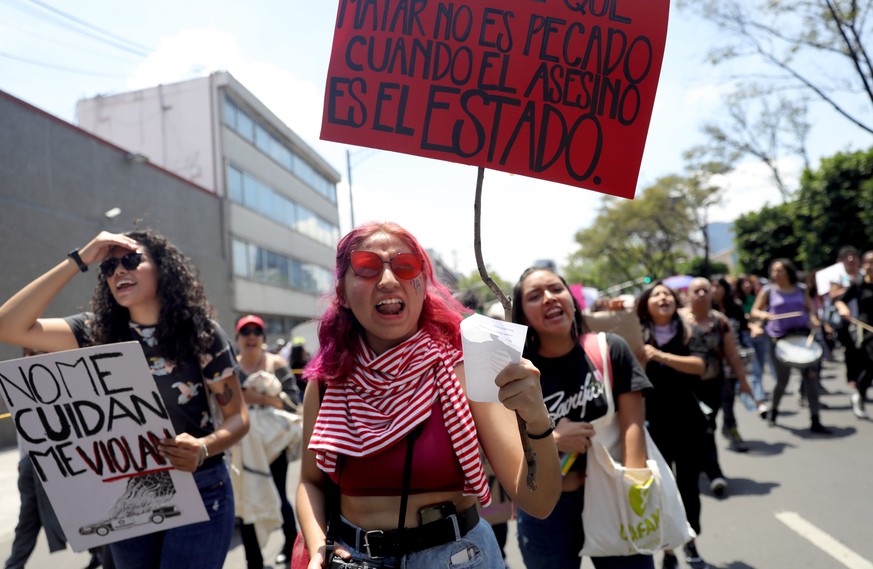 epa07770679 Women hold banners reading &#039;They don&#039;t look after me, they rape me&#039; (L) and &#039;Killing is not a sin when the murderer is the State&#039; (R) during a protest against sexu ...