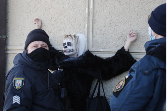 epa09776679 Police detain an activist of the women&#039;s movement FEMEN during her performance in front of the central railway station in Kiev, Ukraine, 22 February 2022. The FEMEN group organized th ...