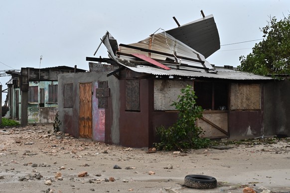 epa12486750 A house stands damaged by the preliminary winds of Hurricane Melissa at Hellshire Fishing Beach in Portmore, Jamaica, 27 October 2025. Jamaican Prime Minister Andrew Holness said the gover ...