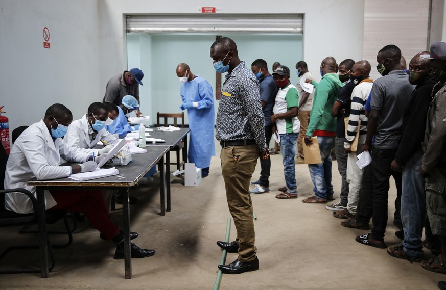 In this photo taken Monday, June 1, 2020, truck drivers entering Kenya queue to be tested for the coronavirus on the Kenya side of the Namanga border crossing with Tanzania. Africa&#039;s long-haul tr ...