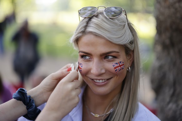 epa09991086 A royal fan has her face painted with a Union Flag in advance of Trooping the Colour for Queen Elizabeth II&#039;s Platinum Jubilee in London, Britain, 02 June 2022. Britain is enjoying a  ...