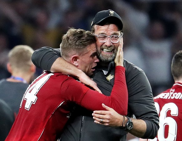 epa07620121 Liverpool head coach Juergen Klopp (R) celebrates with captain Jordan Henderson after the UEFA Champions League final between Tottenham Hotspur and Liverpool FC at the Wanda Metropolitano  ...