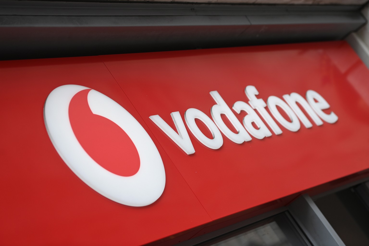 epa10690618 A view of a Vodaphone sign outside a store in London, Britain, 14 June 2023. Vodafone and Three owners CK Hutchison are to merge their UK operations in a deal that will create Britain&#039 ...