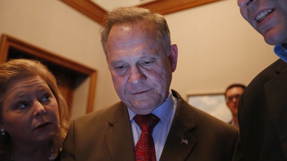 Republican U.S. Senate candidate Roy Moore, center, looks at election returns with staff during an election-night watch party at the RSA activity center, Tuesday, Dec. 12, 2017, in Montgomery, Ala. (A ...