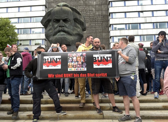 Protesters gather for a far-right protest in front of a Karl Marx monument in Chemnitz, Germany, Monday, Aug. 27, 2018 after a man has died and two others were injured in an altercation between severa ...