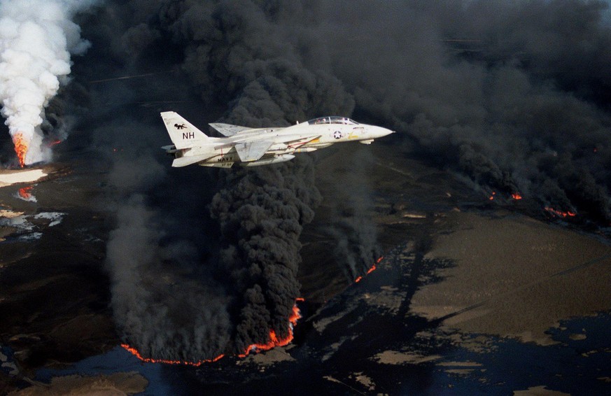 The Kuwaiti oil fires were not just limited to burning oil wells, one of which is seen here in the background, but burning &quot;oil lakes&quot;, seen in the foreground, also contributed to the smoke  ...