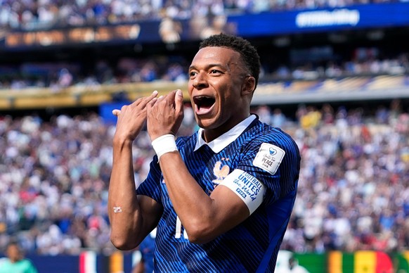 France's Kylian Mbappe celebrates after scoring the opening goal of his team during the World Cup Group I soccer match between France and Senegal in East Rutherford, N.J., near New York, Tuesday, ...