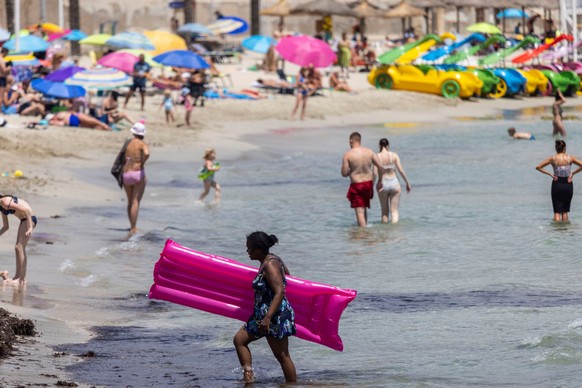 epa09333578 Tourists enjoy the sunny warm weather at Peguera beach in Calvia, Mallorca, Spain, 08 July 2021 (issued 09 July 2021). Germany has classified Spain as a COVID-19 risk area 09 July 2021, am ...