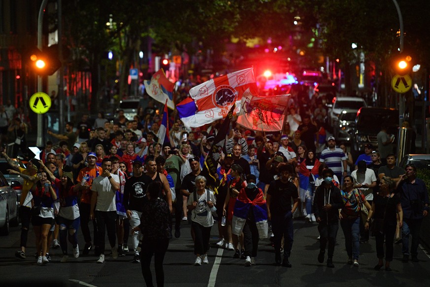 epa09677056 Members of the Serbian community march in Melbourne, Australia, 10 January 2022. Serbian tennis player Novak Djokovic was to be released from an immigration detention center in Melbourne a ...