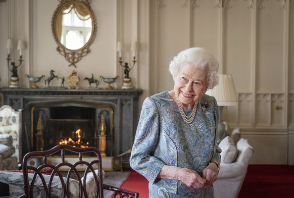 Britain's Queen Elizabeth II smiles while receiving the President of Switzerland Ignazio Cassis and his wife Paola Cassis during an audience at Windsor Castle in Windsor, England, Thursday, April ...