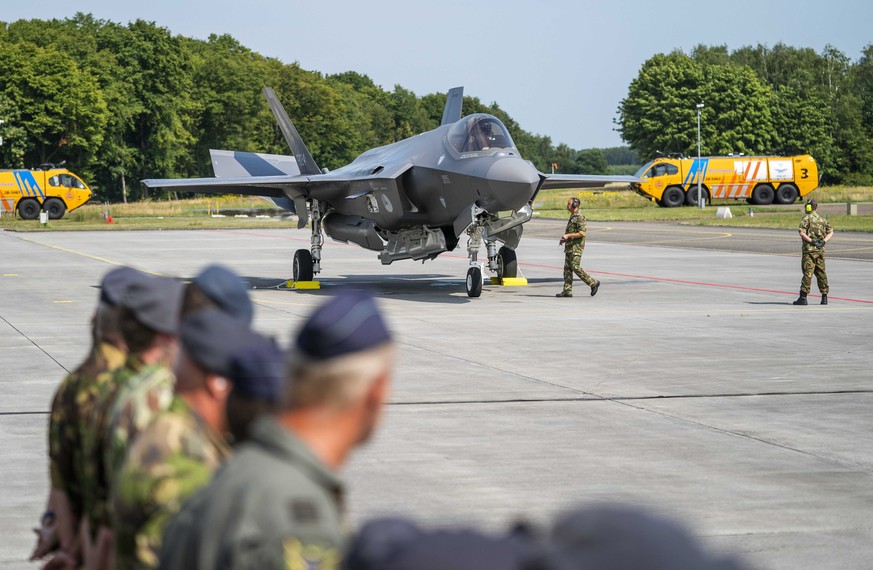 epa10043873 Dutch soldier stand in formation as the first four F-35 fighter planes arrive during a ceremony at the Volkel Air Base in Uden, The Netherlands, 30 June 2022. The F-35s will take over all  ...