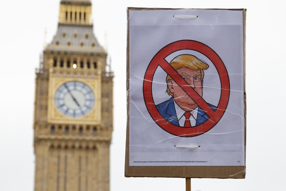 epa12385263 A placard is held aloft in front of the Elizabeth Tower, commonly known as &#039;Big Ben&#039; during a &#039;Stop Trump Coalition&#039; mass demonstration against the state visit to the U ...
