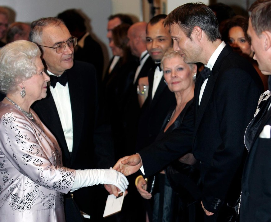 Britain&#039;s Queen Elizabeth II, left, meets cast member Danish actor Mads Mikkelsen, right, during the world premiere of the latest James Bond movie &quot;Casino Royale&quot; at the Odeon cinema in ...