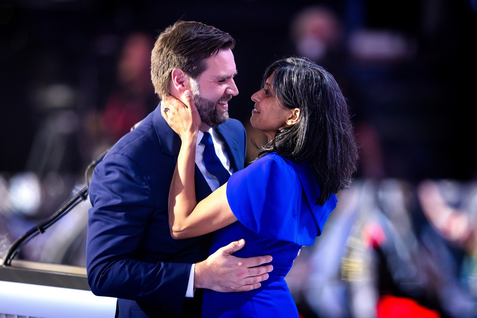 epaselect epa11484707 Vice presidential nominee and Senator from Ohio JD Vance (L) kisses his wife, Usha Vance (R), after he spoke on the third day of the Republican National Convention (RNC) in the F ...