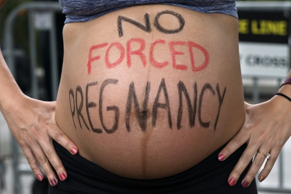 FILE - Krista Bywater shows her eight-months-pregnant belly during an abortion advocacy rally outside the Supreme Court, May 14, 2022, in Washington. (AP Photo/Jacquelyn Martin, File)
Krista Bywater