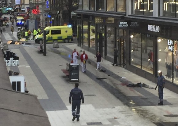 epa05894580 A view of a street after a truck reportedly crashed into a department store in central Stockholm, Sweden, 07 April 2017. A truck has driven into crowds on a street in central Stockholm, me ...