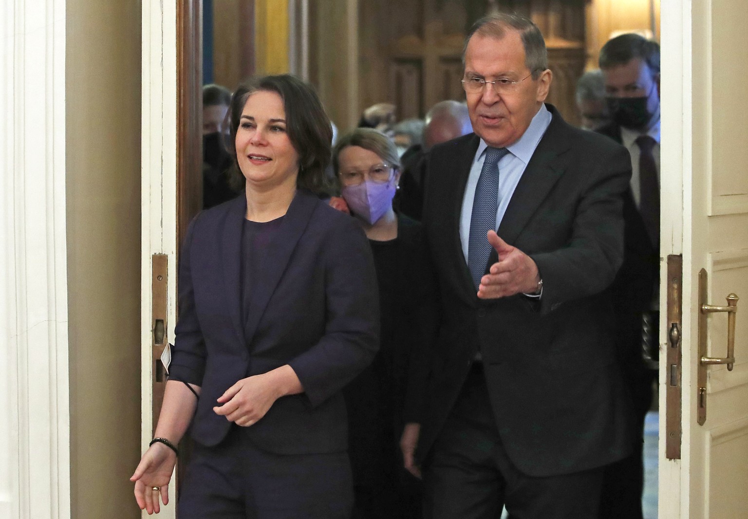 Russian Foreign Minister Sergey Lavrov, right, welcomes German Foreign Minister Annalena Baerbock for talks in Moscow, Russia, Tuesday, Jan. 18, 2022. (Maxim Shemetov/Pool Photo via AP)