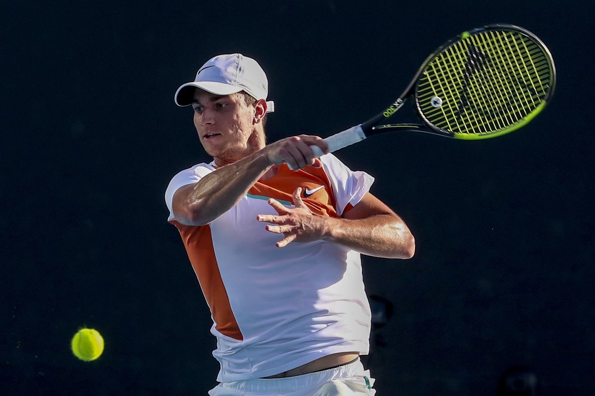 epa09690707 Miomir Kecmanovic of Serbia in action during his Men's Singles first round match against Salvatore Caruso of Italy at the Australian Open Grand Slam tennis tournament in Melbourne, Au ...