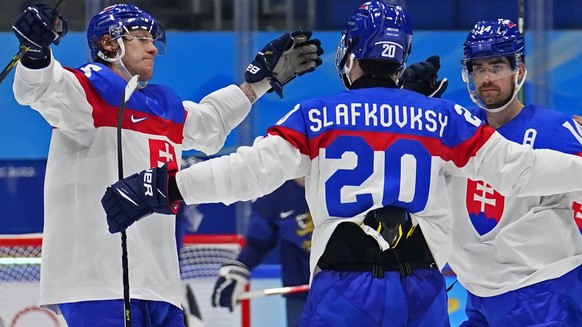 Slovakia&#039;s Juraj Slafkovsky (20) is congratulated after scoring a goal against Finland during a preliminary round men&#039;s hockey game at the 2022 Winter Olympics, Thursday, Feb. 10, 2022, in B ...