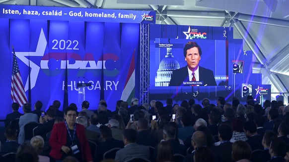 American television host and conservative political commentator Tucker Carlson is seen on screen delivering a speech at the CPAC conference in Budapest, Hungary, Thursday, May 19, 2022. Dozens of prom ...