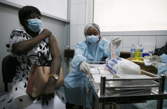 epa09416996 An Ivorian woman receives the first injection of the vaccine against the Ebola virus, in a vaccination center at the University Hospital of Cocody in Abidjan, Cote d'Ivoire, 16 August 2021 ...