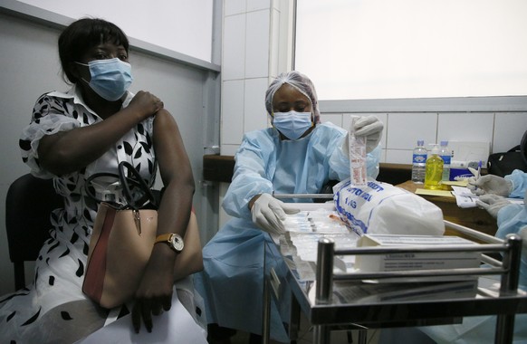 epa09416996 An Ivorian woman receives the first injection of the vaccine against the Ebola virus, in a vaccination center at the University Hospital of Cocody in Abidjan, Cote d&#039;Ivoire, 16 August ...