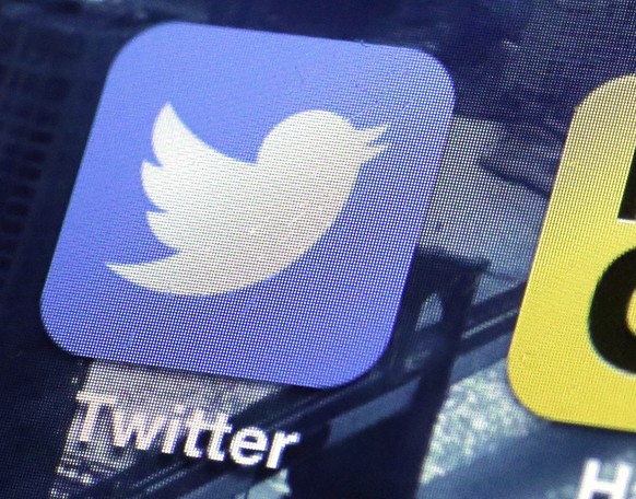 FILE - This Friday, Oct. 18, 2013, file photo, shows a Twitter app on an iPhone screen in New York. Twitter has suspended the accounts of several prominent members of the so-called “alt-right” in an a ...