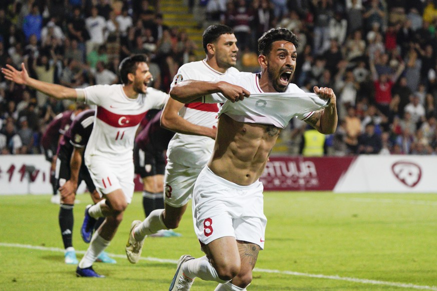 Turkey&#039;s Irfan Can Kahveci, right, celebrates after scoring his side&#039;s third goal during the Euro 2024 group D qualifying soccer match between Latvia and Turkey at Skonto Stadium in Riga, La ...