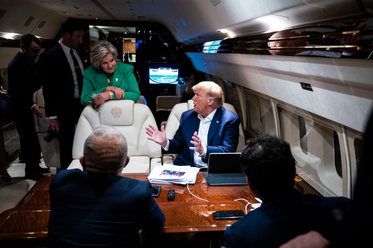 GREENSBORO, NC - June 10 : Susie Wiles stands by as former president Donald Trump speaks to staff and reporters aboard his airplane, known as "Trump Force One," as he travels home after spea ...